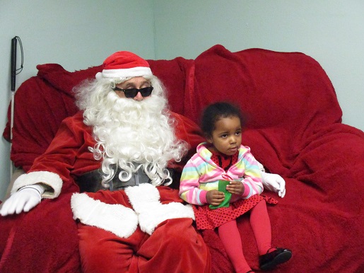 Blind Santa sitting with a little girl